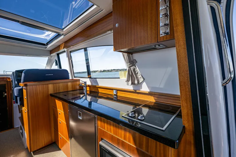 Slide: The Image of Luxurious interior of 2021 Nimbus 405 Coupé yacht with modern kitchen and panoramic windows. - 18