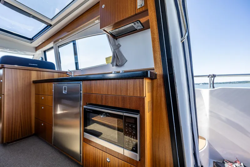 Slide: The Image of Luxurious interior of 2021 Nimbus 405 Coupé yacht with modern kitchen amenities. - 19