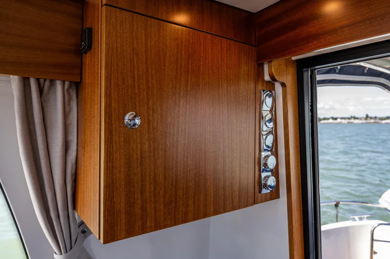 Slide: The Image of Wooden cabinet and chrome details inside a 2021 Nimbus 405 Coupé yacht, with ocean view. - 21