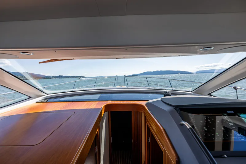 Slide: The Image of Interior view from a 2021 Nimbus 405 Coupé yacht, overlooking the sea and distant mountains. - 31