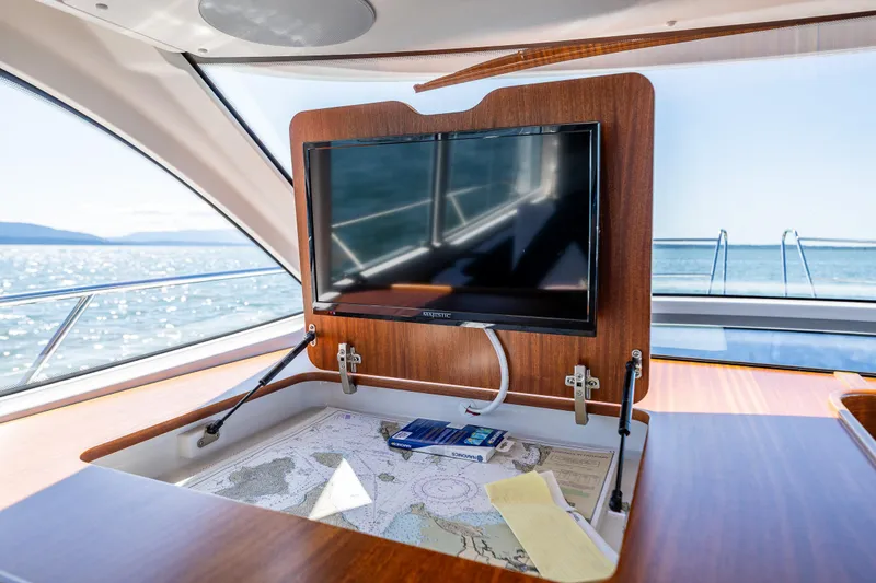 Slide: The Image of Interior of 2021 Nimbus 405 Coupé yacht with TV and navigation map. - 32