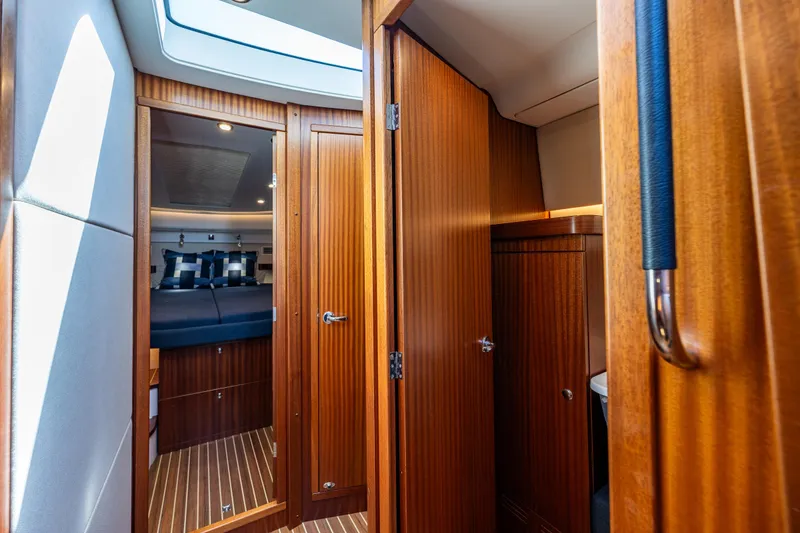 Slide: The Image of Interior of 2021 Nimbus 405 Coupé #88, featuring wooden cabinetry and cozy cabin space. - 39