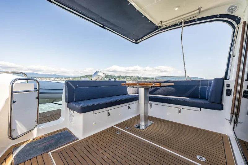 Slide: The Image of Luxurious 2021 Nimbus 405 Coupé yacht interior with elegant seating and scenic water view. - 9