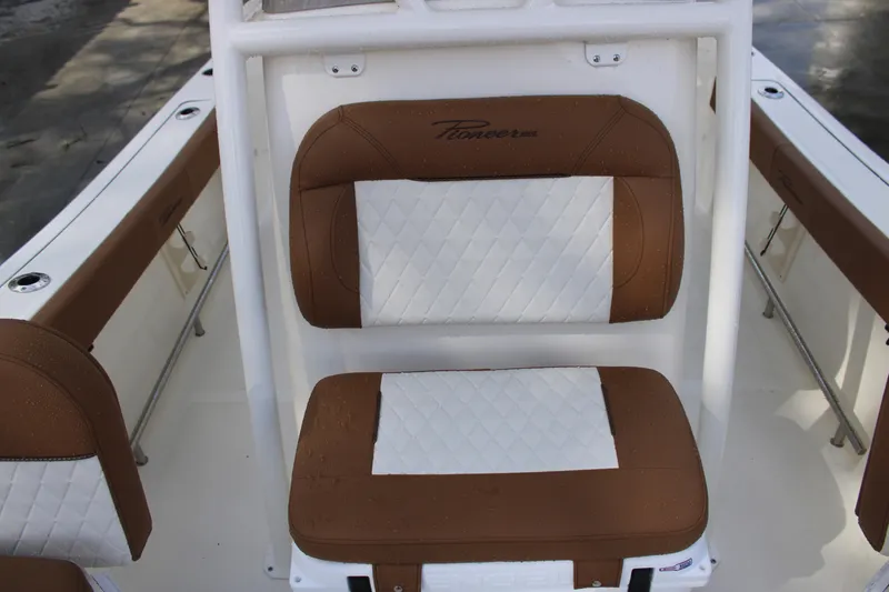 Slide: The Image of 2025 Pioneer 220 Bay Sport boat seat with brown and white upholstery. - 12