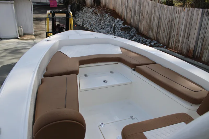 Slide: The Image of 2025 Pioneer 220 Bay Sport boat with brown seating and white deck. - 5