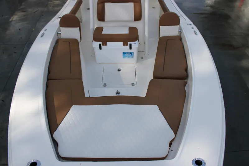 Slide: The Image of 2025 Pioneer 220 Bay Sport boat interior with brown and white seating. - 6