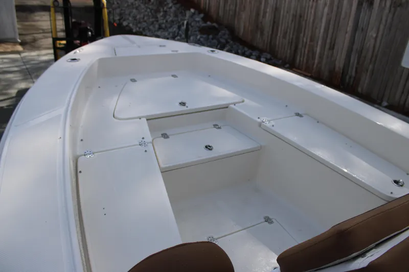 Slide: The Image of 2025 Pioneer 220 Bay Sport boat interior with storage compartments and seating. - 7