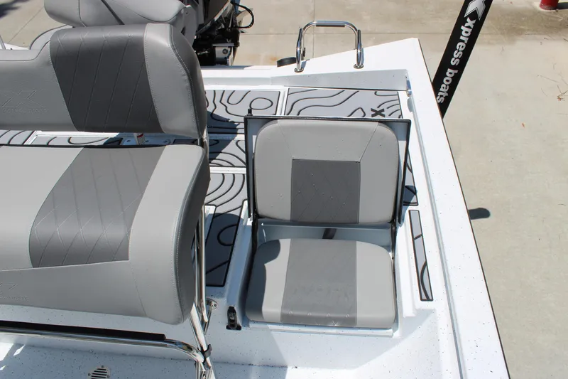 Slide: The Image of 2026 Xpress H22B Bay boat with gray seating and stylish deck design. - 11