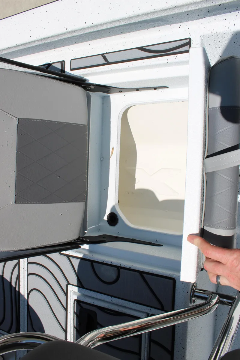 Slide: The Image of 2026 Xpress H22B Bay boat interior with storage compartment and seating detail. - 12