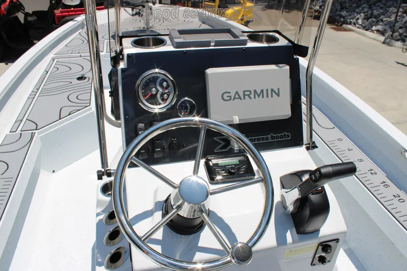 Slide: The Image of 2026 Xpress H22B Bay boat dashboard with Garmin navigation system and steering wheel. - 13
