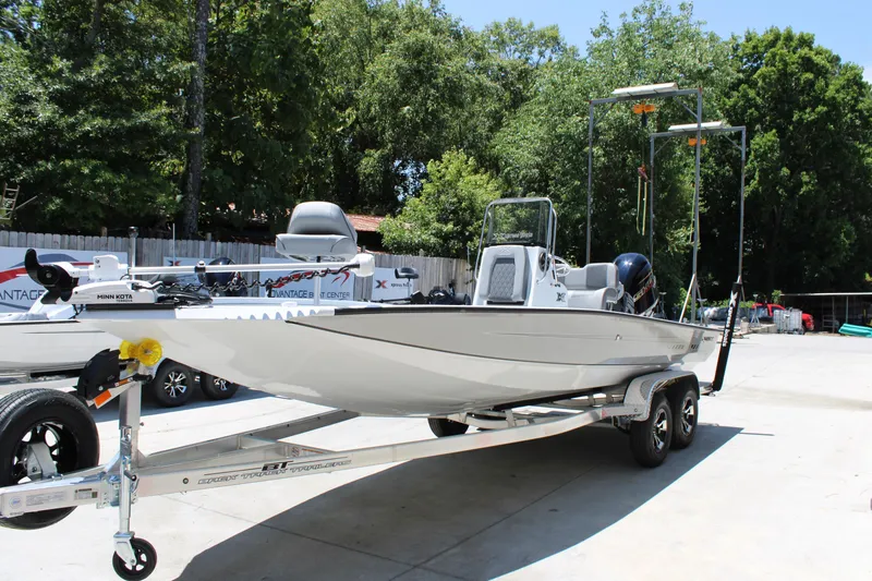 Slide: The Image of 2026 Xpress H22B Bay boat on trailer, parked outdoors with trees in background. - 3