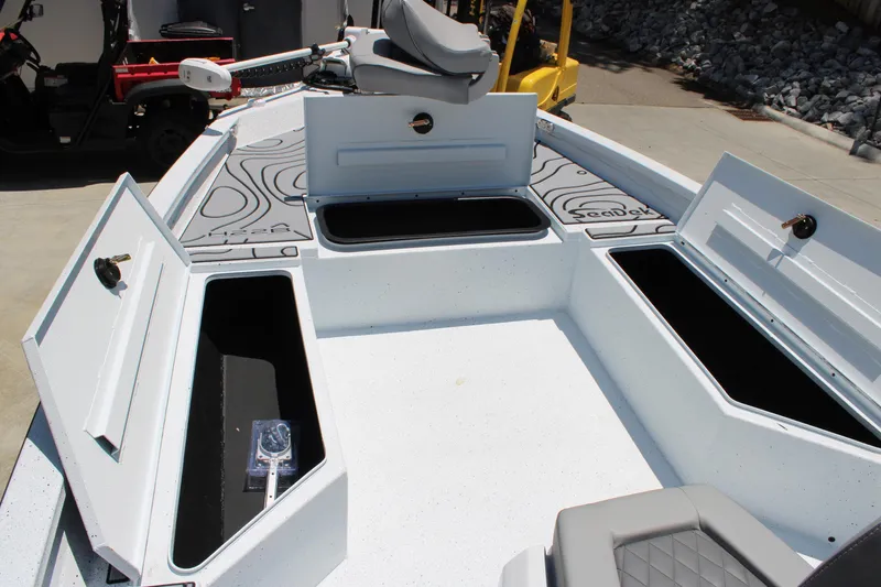 Slide: The Image of 2026 Xpress H22B Bay boat interior with open storage compartments and seating. - 5