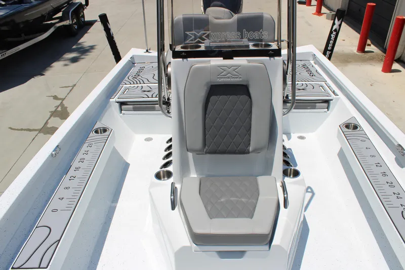 Slide: The Image of 2026 Xpress H22B Bay boat interior with gray seating and measurement decals. - 7