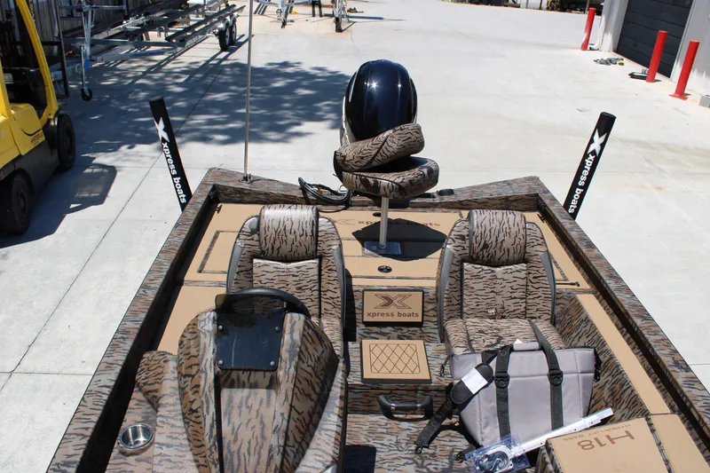 Slide: The Image of 2026 Xpress H18 boat interior with camouflage seats and accessories. - 10