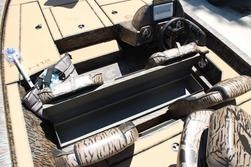 Slide: The Image of 2026 Xpress H18 boat interior with camouflage seats and Garmin navigation system. - 11
