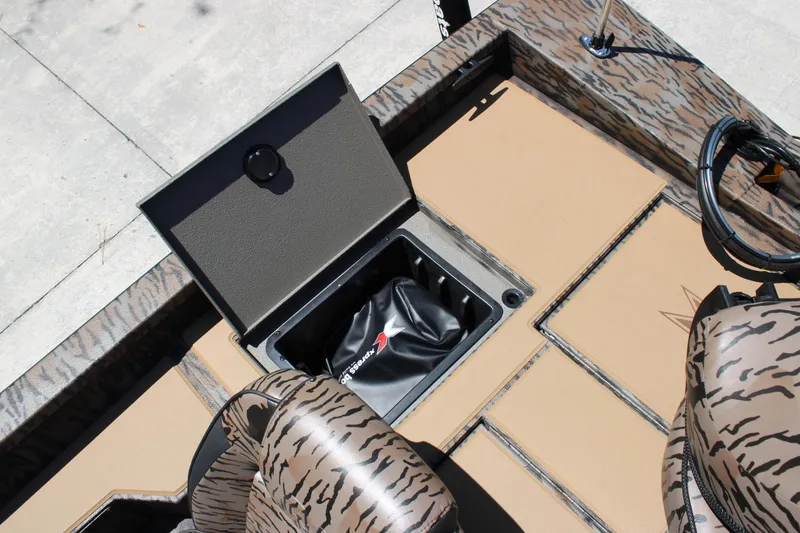 Slide: The Image of 2026 Xpress H18 boat interior with open storage compartment and camouflage seating. - 12