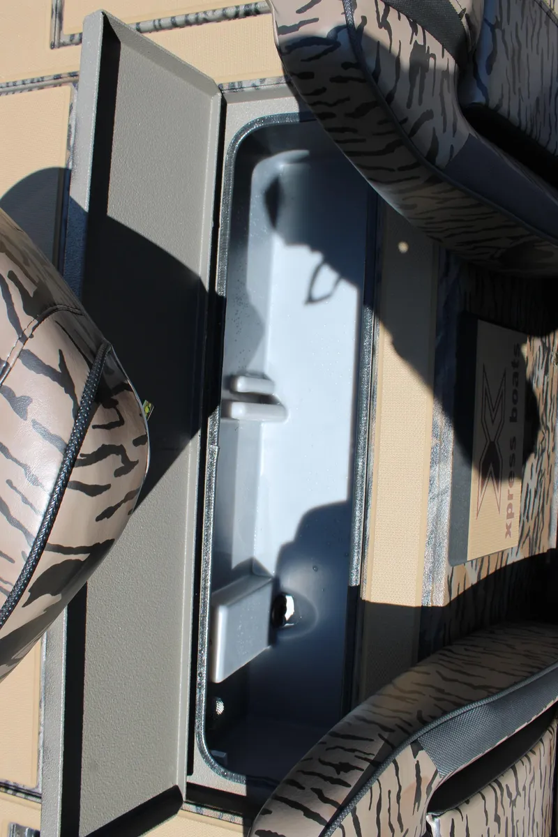 Slide: The Image of 2026 Xpress H18 boat interior with camo seats and storage compartment. - 13