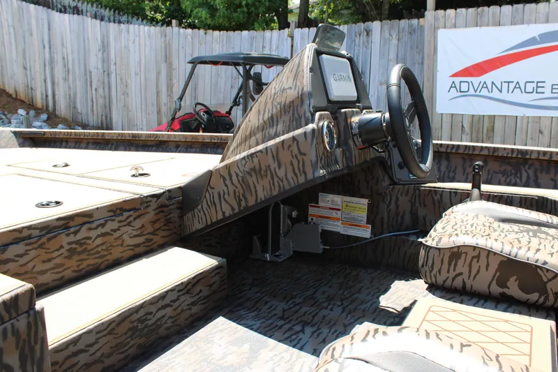 Slide: The Image of 2026 Xpress H18 boat interior with camouflage design and Garmin navigation system. - 15