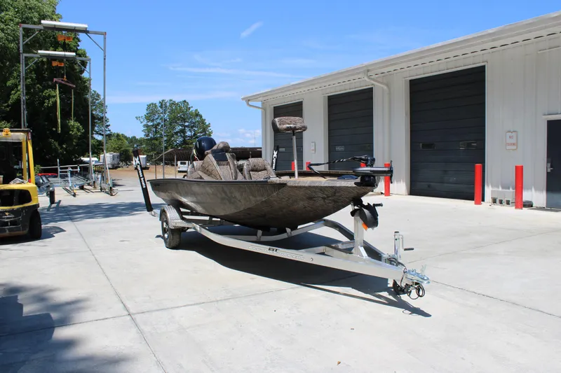 Slide: The Image of 2026 Xpress H18 boat on trailer outside industrial building under clear sky. - 4