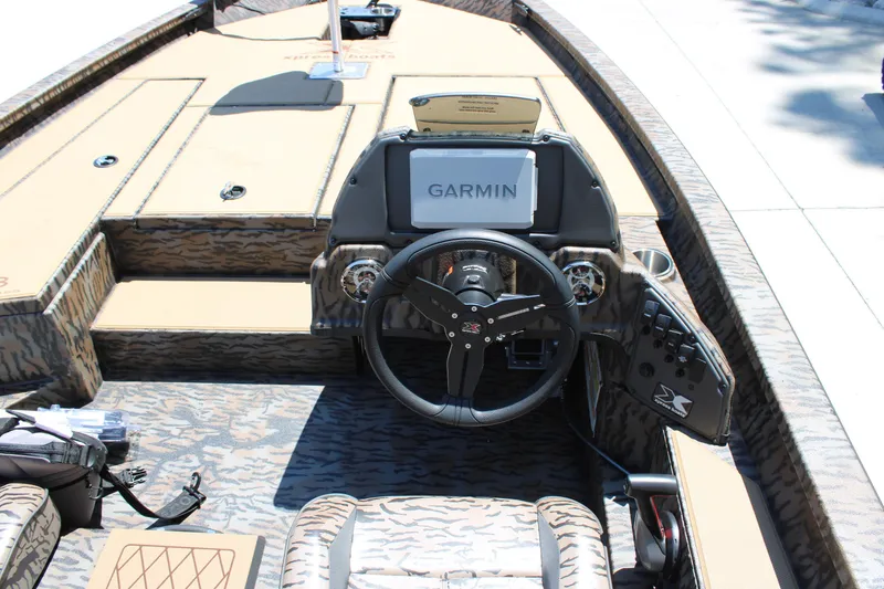Slide: The Image of 2026 Xpress H18 boat interior with Garmin navigation system and camo design. - 5