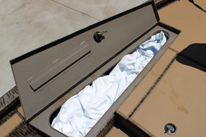 Slide: The Image of Open storage compartment in 2026 Xpress H18 boat, revealing white fabric inside. - 7