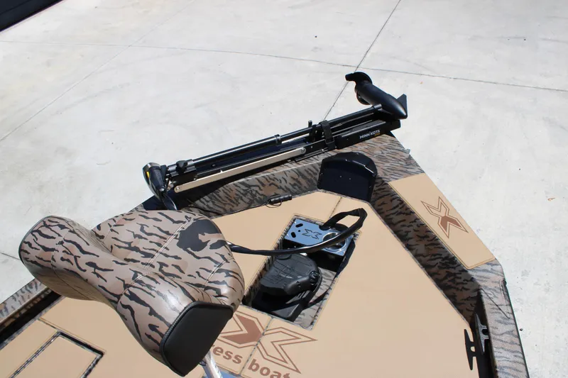 Slide: The Image of 2026 Xpress H18 boat with camo seat and Minn Kota trolling motor. - 9