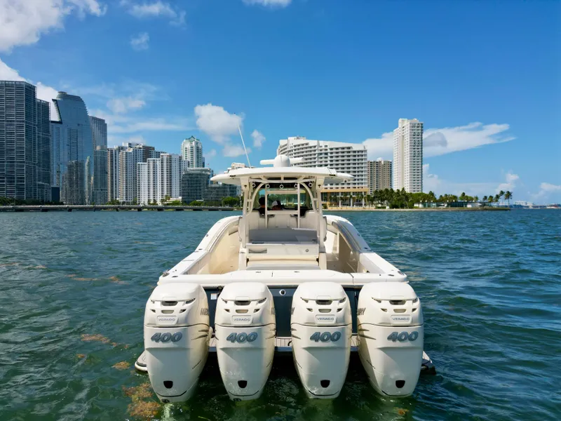 Slide: The Image of 2021 Scout 380 LXF boat with four engines, city skyline in background. - 14