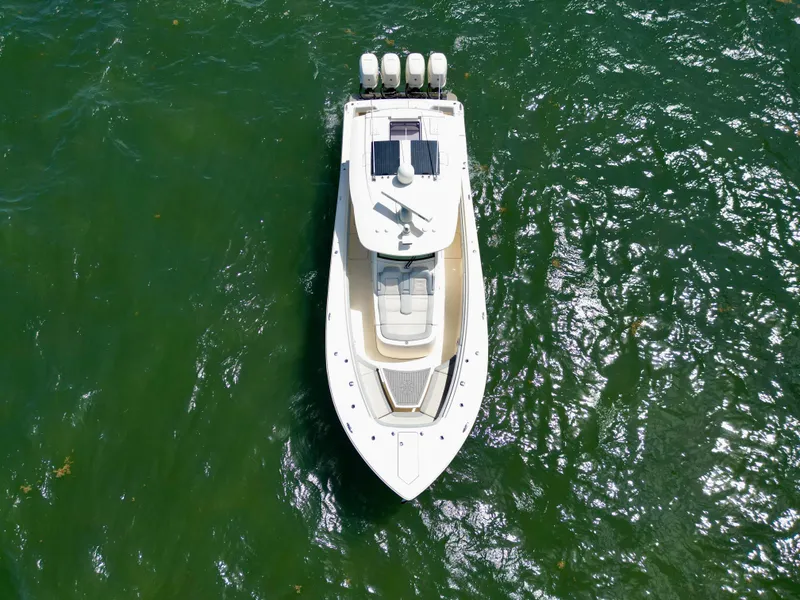 Slide: The Image of Aerial view of 2021 Scout 380 LXF boat on green water. - 17