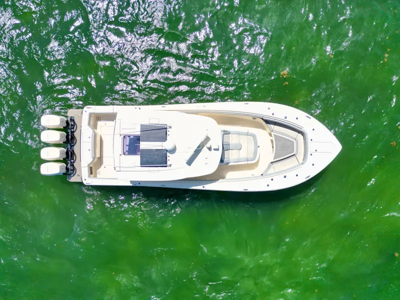 Slide: The Image of Aerial view of 2021 Scout 380 LXF boat on vibrant green water. - 19