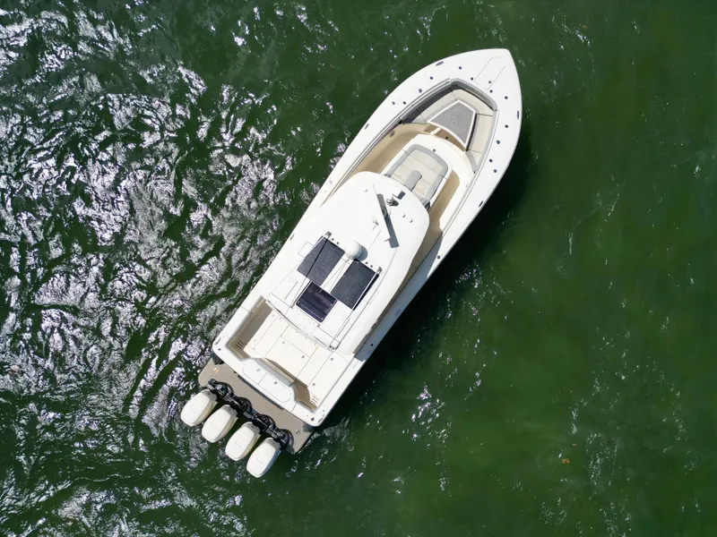 Slide: The Image of Aerial view of 2021 Scout 380 LXF boat on green water. - 20