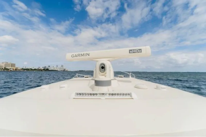 Slide: The Image of 2021 Scout 380 LXF boat with Garmin xHD2 radar on open water under blue sky. - 21