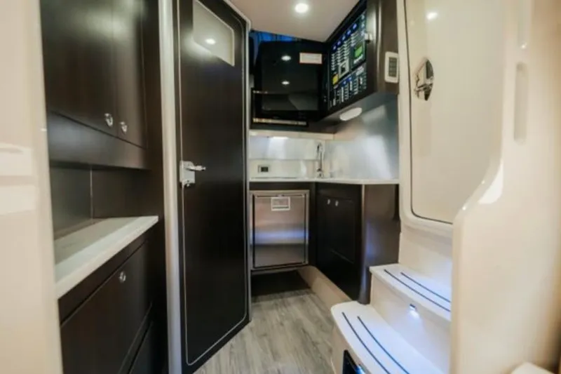 Slide: The Image of 2021 Scout 380 LXF interior cabin with modern kitchen and sleek design. - 23