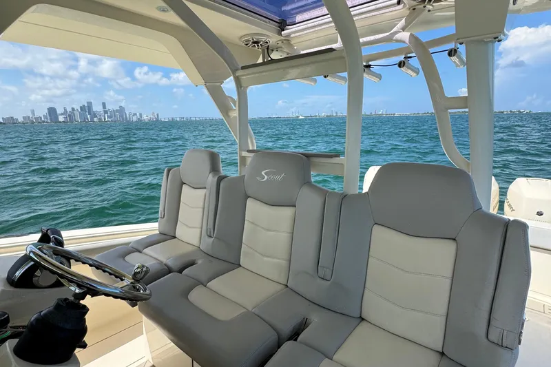 Slide: The Image of 2021 Scout 380 LXF boat interior with city skyline and ocean view. - 24