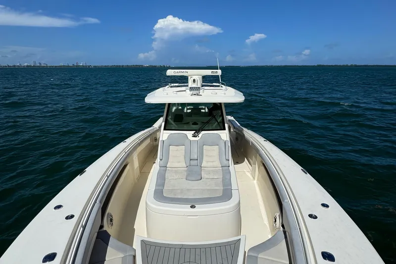 Slide: The Image of 2021 Scout 380 LXF boat on open water under clear blue sky. - 26
