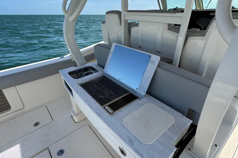 Slide: The Image of 2021 Scout 380 LXF boat with outdoor kitchen setup on deck. - 28