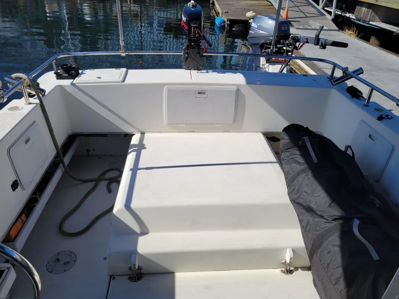 Slide: The Image of 2001 SeaSport 2700 Navigator boat interior with storage compartments and docked outboard motor. - 11