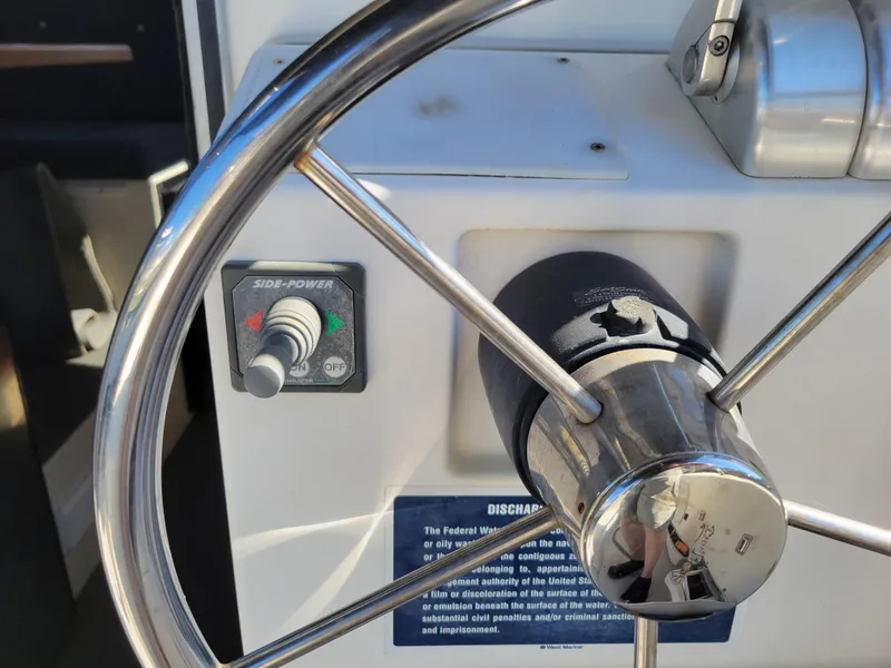 Slide: The Image of Steering wheel and controls of a 2001 SeaSport 2700 Navigator boat. - 13