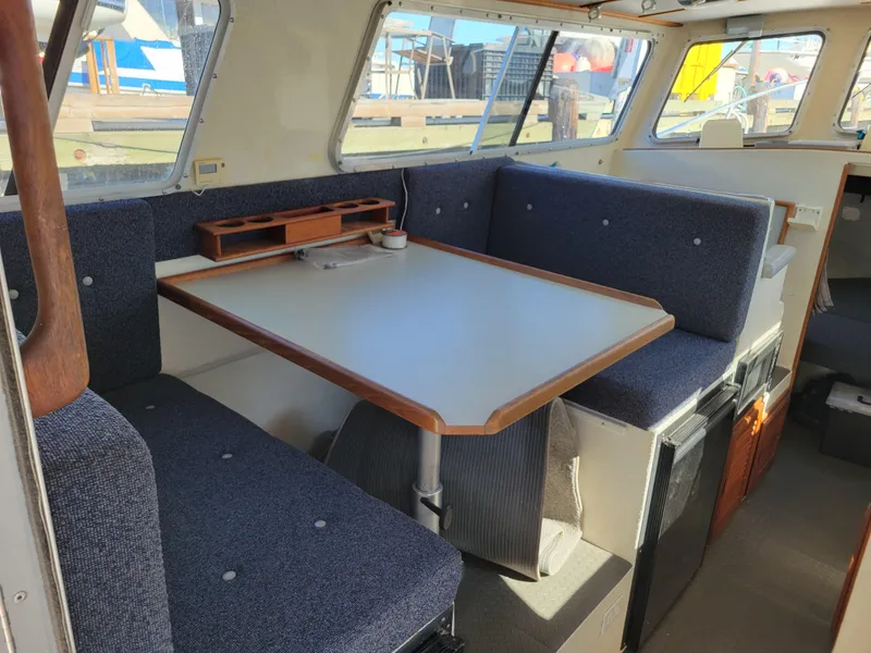 Slide: The Image of Interior of a 2001 SeaSport 2700 Navigator boat with a cozy dining area. - 17