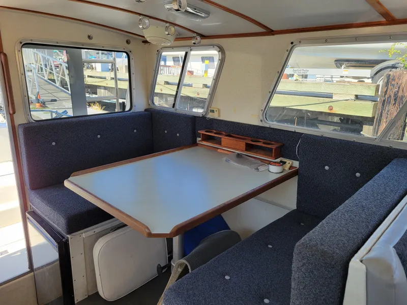 Slide: The Image of Interior of 2001 SeaSport 2700 Navigator with dining area and large windows. - 18