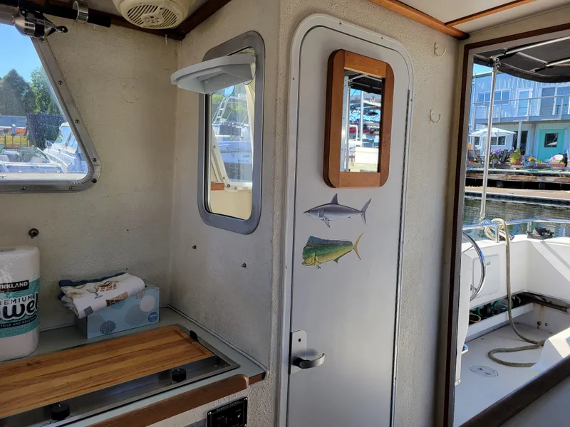 Slide: The Image of Interior of a 2001 SeaSport 2700 Navigator boat with nautical decor and dock view. - 20