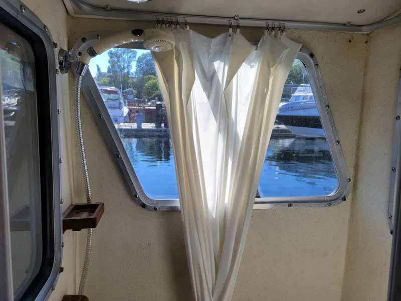 Slide: The Image of Interior view of 2001 SeaSport 2700 Navigator with window and curtain, overlooking marina. - 22
