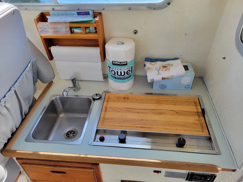 Slide: The Image of Compact kitchen area in a 2001 SeaSport 2700 Navigator boat with sink and stove. - 23