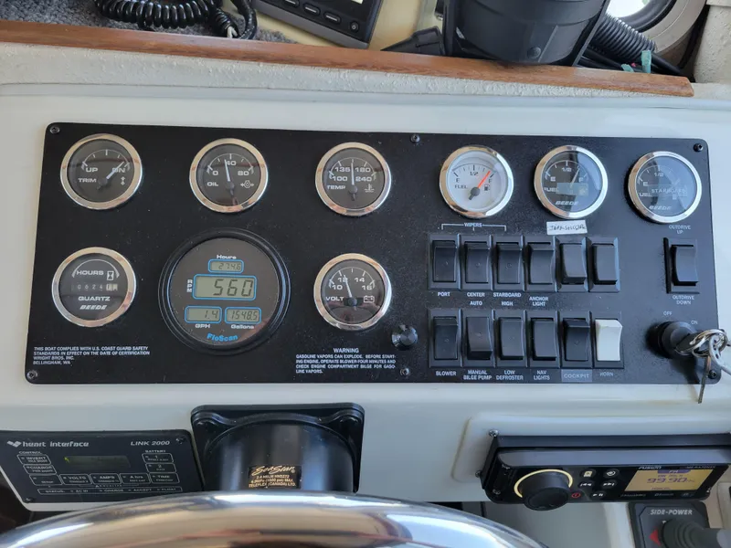 Slide: The Image of Control panel of a 2001 SeaSport 2700 Navigator boat with gauges and switches. - 32