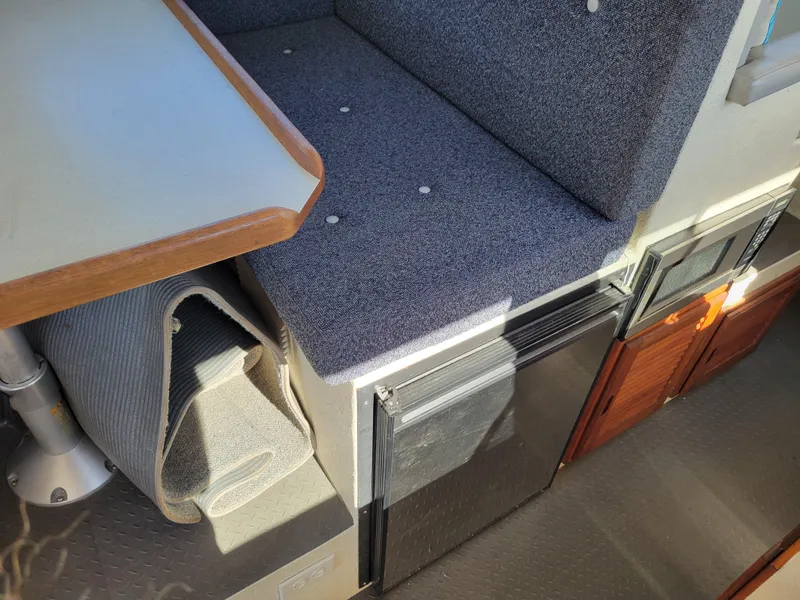 Slide: The Image of Interior of a 2001 SeaSport 2700 Navigator boat with seating and storage. - 35