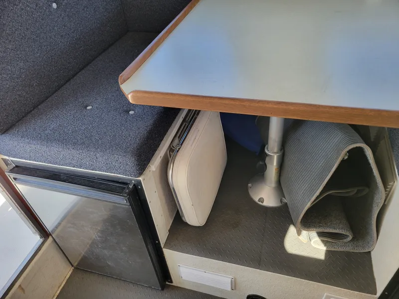 Slide: The Image of Interior of 2001 SeaSport 2700 Navigator with seating, table, and storage area. - 36