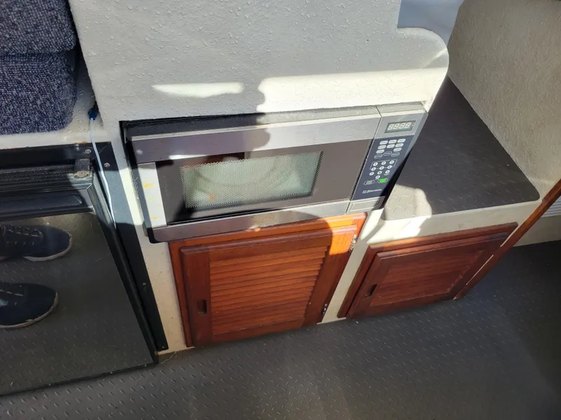 Slide: The Image of Microwave and cabinets inside a 2001 SeaSport 2700 Navigator boat interior. - 37