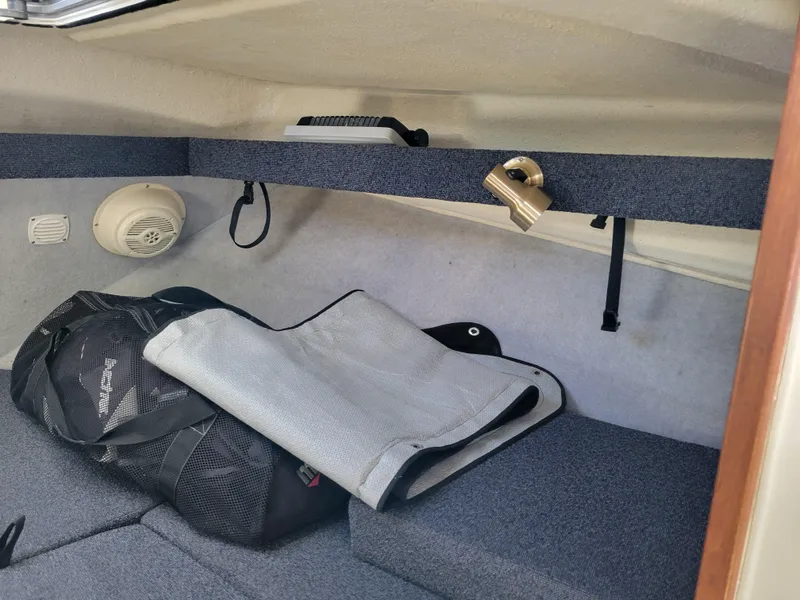 Slide: The Image of Interior of a 2001 SeaSport 2700 Navigator boat with storage and speaker. - 38