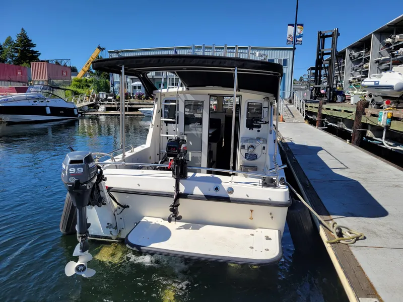 Slide: The Image of 2001 SeaSport 2700 Navigator boat docked at marina with Yamaha outboard motor. - 4