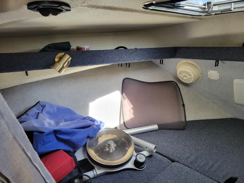 Slide: The Image of Interior cabin of a 2001 SeaSport 2700 Navigator boat with various items stored. - 40