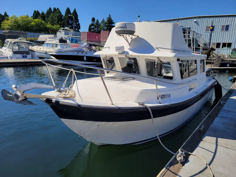 Slide: The Image of 2001 SeaSport 2700 Navigator boat docked at marina, clear blue sky. - 6